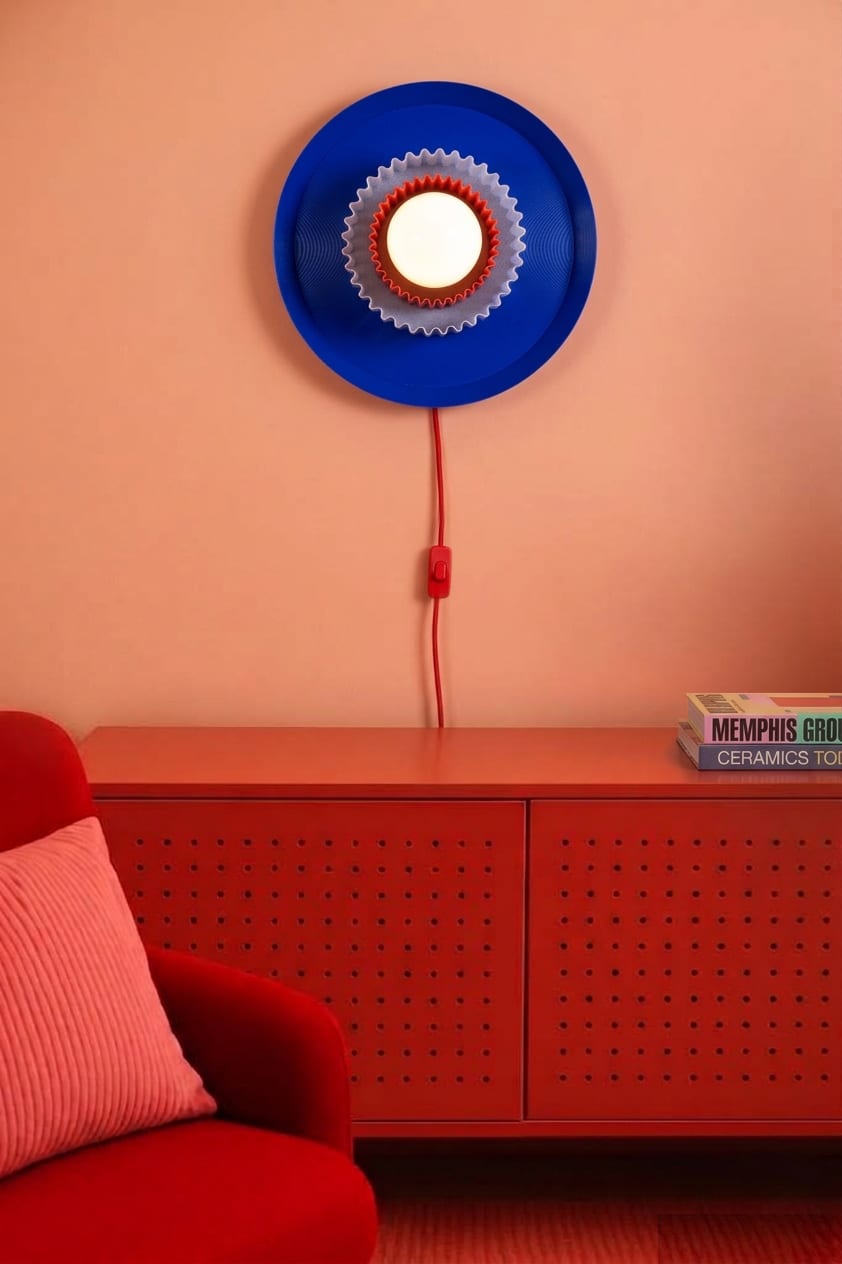 Visualization: blue Bunta wall lamp on a red wall